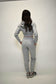 Person wearing a gray tracksuit against a white background